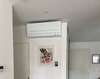 technicien installant climatisation dans logement moderne