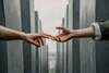Two hands touching, symbolizing an emotional breakup