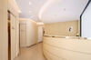 View of the modern and elegant interior of Doctor Rocco's dental practice in Monaco, showing the reception and access to treatment rooms.