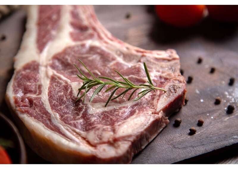 vue-rapprochee-avant-tranche-de-viande-crue-avec-des-tomates-rouges-fraiches-sur-la-surface-en-bois__1_