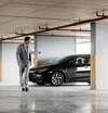 Homme en costume dans parking souterrain inspectant canalisations