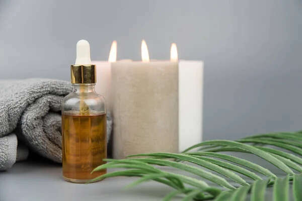 depositphotos_378066074-stock-photo-towel-aromatic-candles-bottle-natural