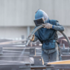 Équipe réalisant sablage sur structure métallique