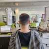 homme et femme discutent coiffure masculine personnalisée devant ordinateurs