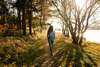 Femme marchant sur sentier naturel symbole d'accompagnement global