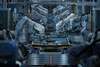 automated factory with robotic arms assembling parts on a conveyor belt