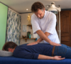 mains exerçant des pressions sur un dos nu