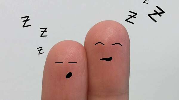 two fingers with drawing of sleeping face