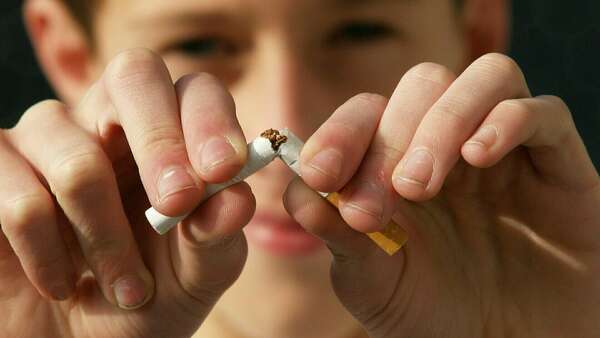 man breaking a cigarette