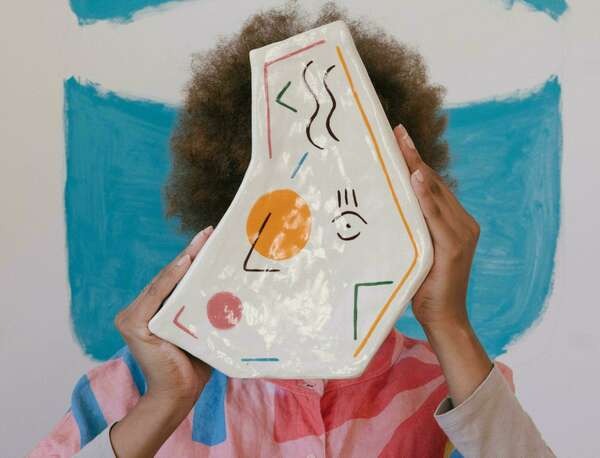 face hidden behind sculpture