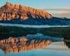 Montagnes enneigées reflétées dans un lac calme au lever du soleil