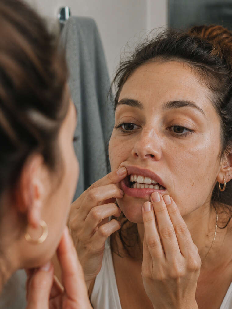 Patiente vérifiant l’alignement de ses dents après un traitement orthodontique
